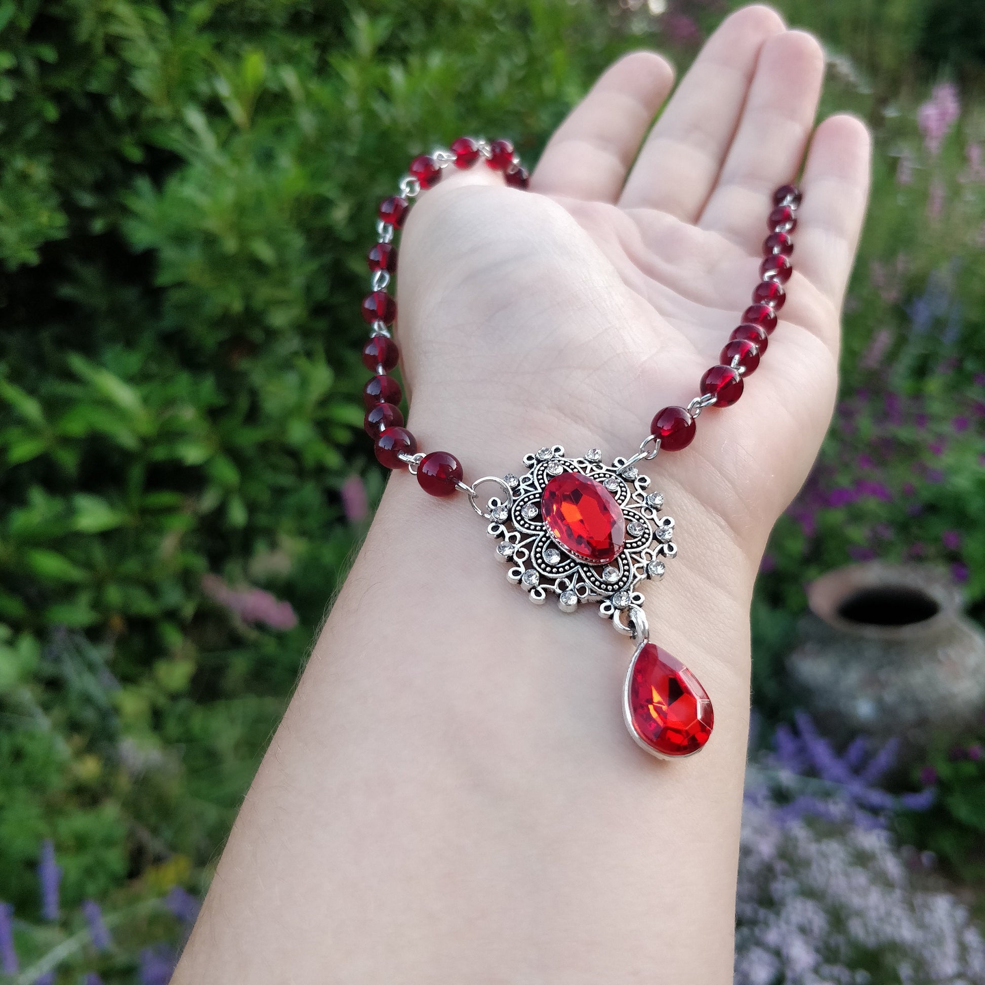 red-transparent-beads-with-elegant-retro-centre-charm