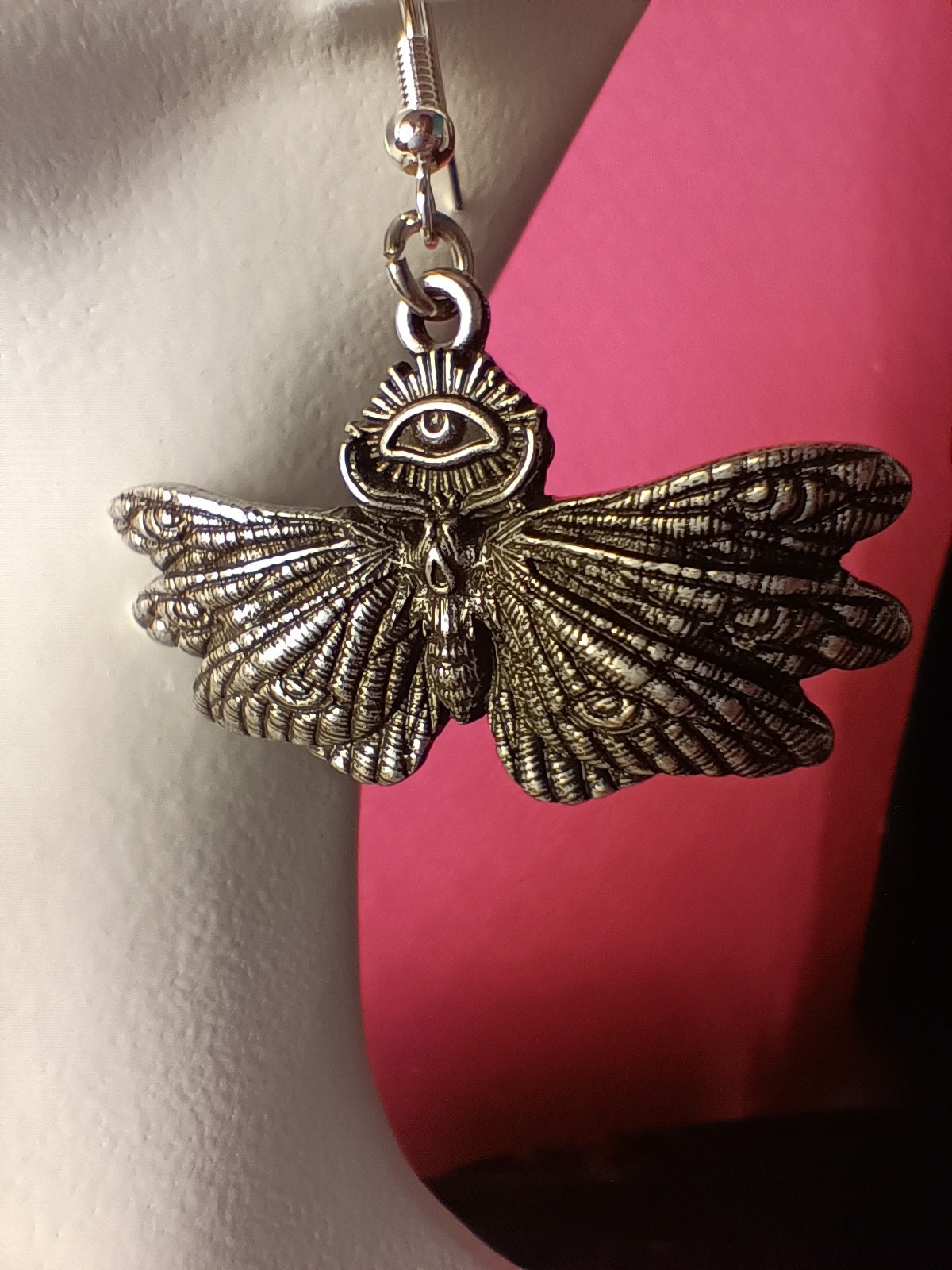 occult moth earrings, magical third eye. engraved, skull face and eyes on wings